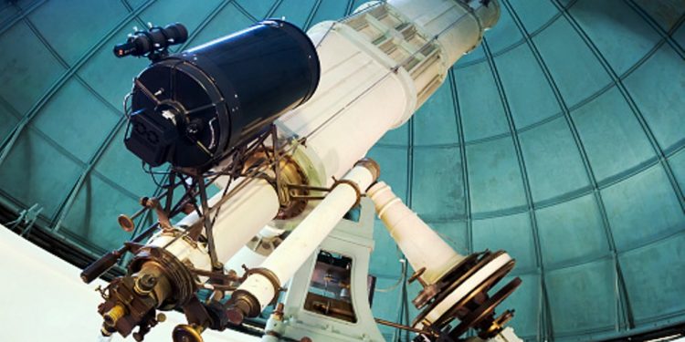 modern large telescope in observatory with windows closed