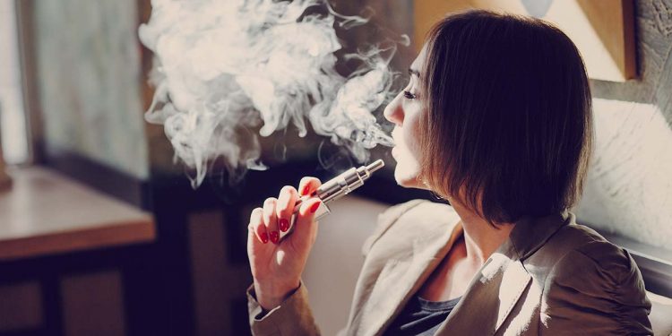 young woman smoking electronic cigarette