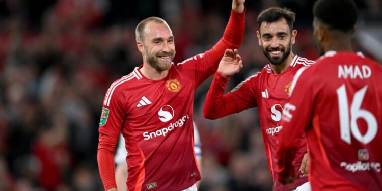 MANCHESTER, ENGLAND - SEPTEMBER 17: Christian Eriksen of Manchester United celebrates scoring his team's sixth goal with teammates Bruno Fernandes and mun16as during the Carabao Cup Third Round match between Manchester United and Barnsley at Old Trafford on September 17, 2024 in Manchester, England. (Photo by Stu Forster/Getty Images)