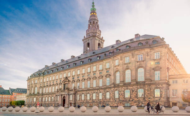 Christiansborg Palace with Christiansborg tower - the seat of the Danish Parliament in the rays of the setting sun. Copenhagen, Denmark